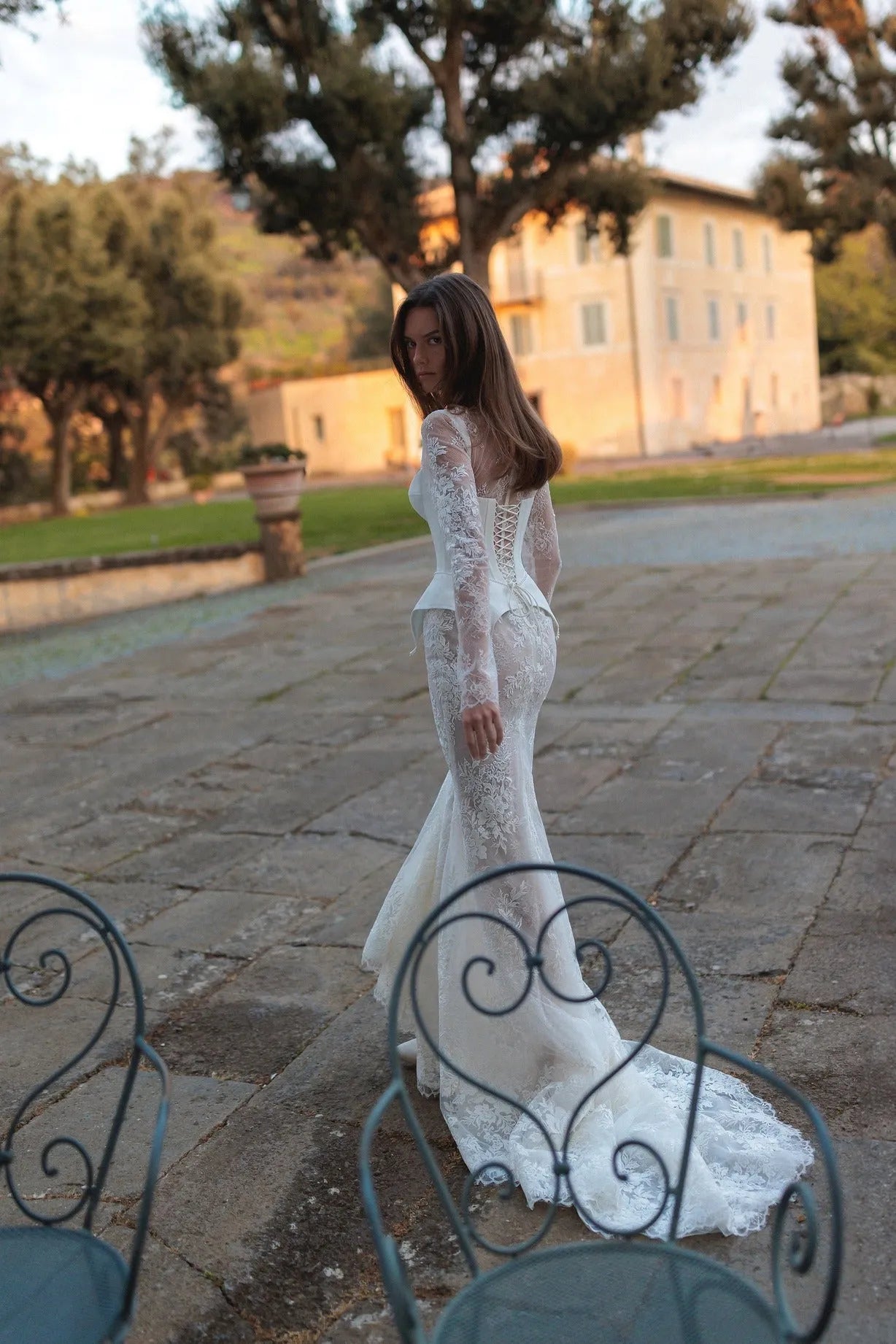 Meticulously detailed embroidery over the translucent long sleeve top and smooth mermaid tail skirt.