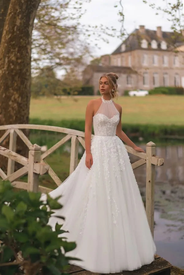 Elegant A-Line Wedding Dress with Halter Neckline, Open Shoulders, and Pearl Embellishments