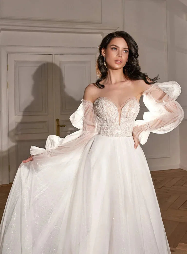 Classic A-Line Bridal Gown with Long Sleeves, Nude Neckline, Lace Embellishments, and Natural Waistline