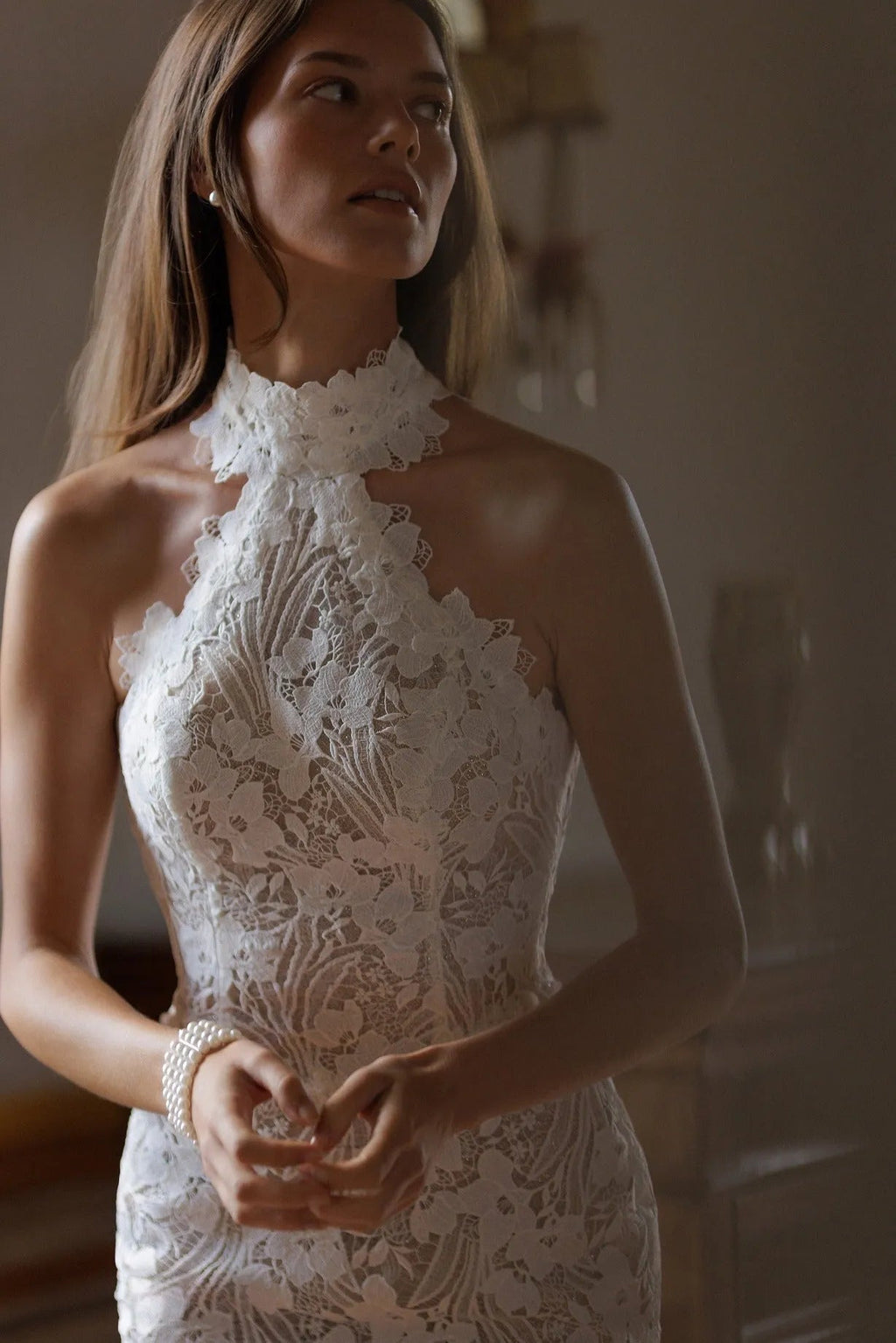Sleeveless turtleneck top with mermaid tail skirt made of guipure-lace featuring floral ornament all over the dress.